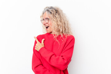 Middle age caucasian woman isolated on white background looks aside smiling, cheerful and pleasant.
