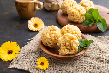 Traditional Tatar candy chak-chak made of dough and honey with cup of coffee on a black concrete background. Side view.