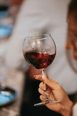 Red wine by the glass at a tasting of white, rosé and red wines that celebrates friendship and joy at the highest level with your best friends on a weekend evening full of people from social media.