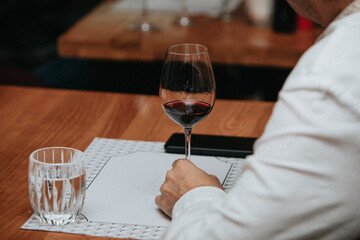 Red wine by the glass at a tasting of white, rosé and red wines that celebrates friendship and joy at the highest level with your best friends on a weekend evening full of people from social media.