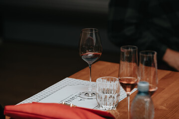Red wine by the glass at a tasting of white, rosé and red wines that celebrates friendship and joy at the highest level with your best friends on a weekend evening full of people from social media.