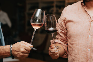 Red wine by the glass at a tasting of white, rosé and red wines that celebrates friendship and joy at the highest level with your best friends on a weekend evening full of people from social media.