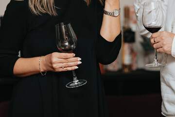 Red wine by the glass at a tasting of white, rosé and red wines that celebrates friendship and joy at the highest level with your best friends on a weekend evening full of people from social media.