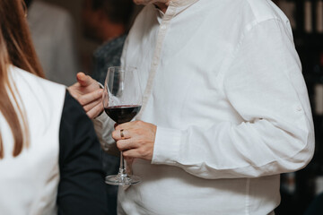 Red wine by the glass at a tasting of white, rosé and red wines that celebrates friendship and joy at the highest level with your best friends on a weekend evening full of people from social media.