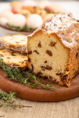 Homemade easter pie with raisins and eggs on plate on a gray concrete background. side view, selective focus.