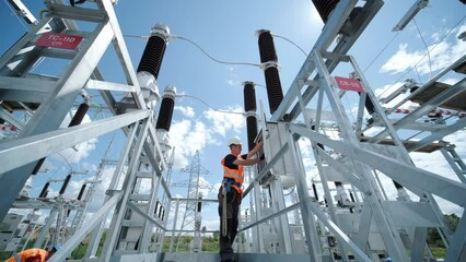 Electrical engineers inspect the electrical systems at the equipment control cabinet