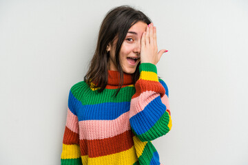 Young caucasian woman isolated on white background having fun covering half of face with palm.