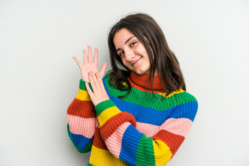 Young caucasian woman isolated on white background feeling energetic and comfortable, rubbing hands confident.