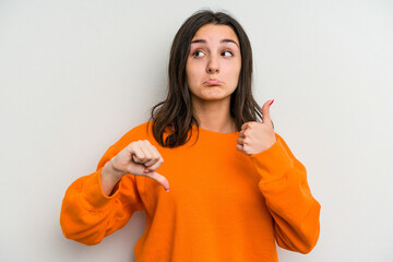 Young caucasian woman isolated on white background showing thumbs up and thumbs down, difficult...
