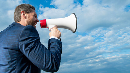 businessman promote in loudspeaker on sky background