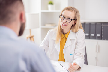 Consultation in doctor's office, woman psychologist talking with man client about health care, help...
