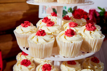 Luxury wedding candy bar table set. Tower or pyramid and cupcakes on sweet dessert table