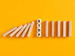 To stop the domino risk effect or risk prevention in business concept.