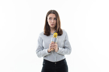 A young woman came up with the idea of what to sing in karaoke. Portrait of a beautiful young woman with a microphone in her hands on a white background. Karaoke club