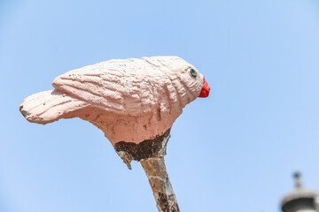 statue of birds sitting on a branch of a tree