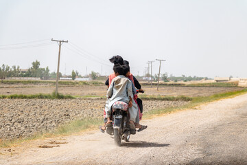 Obraz premium for friends are ridding a bike in a village and enjoying 