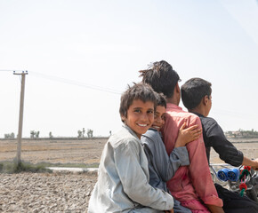 for friends are ridding a bike in a village and enjoying 