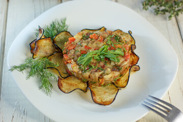 Grilled eggplant salad on a white plate