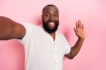 Photo of cheerful funny person take selfie arm palm waving hi isolated on pink color background © deagreez