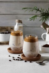 Glasses of dalgona coffee on the white table 