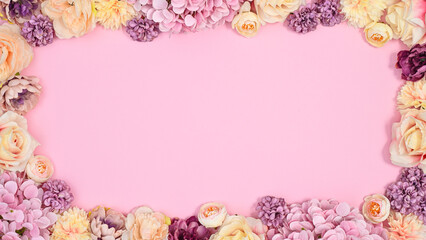 Copy space background with romantic flowers frame on pastel pink theme. Flat lay