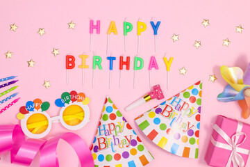 Birthday party background with party accessories on pastel pink theme. Flat lay