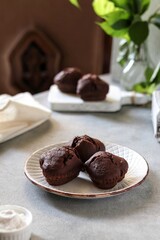 Chocolate muffins with banana and cocoa on the white table 