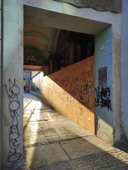 Arcade passage in the city of Wrocław, sun, neglected alley