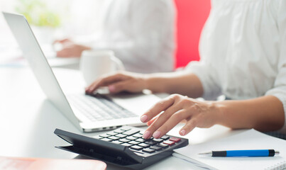 Business woman or accountant working with financial investment on calculator, calculating, analyzing business and marketing growth on financial documents data graph, accounting, economic, commercial 