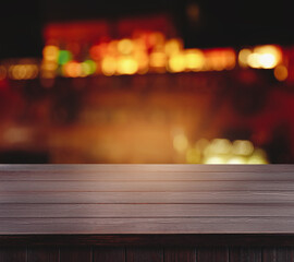 Empty wooden surface and blurred view of bar interior. Space for design