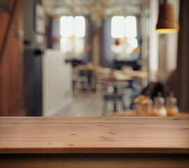 Empty wooden surface and blurred view of cafe interior. Space for design