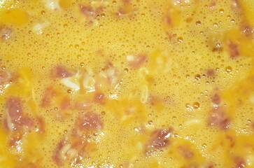 raw chop pork tmixed in egg for cooking on plate