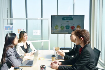 Asian business man and woman meeting and disussing work in office room