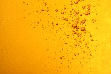 Tasty beer with bubbles as background, closeup
