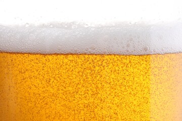 Tasty beer with foam in glass, closeup