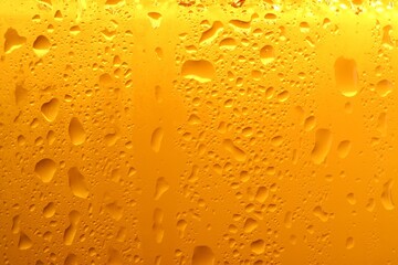 Glass of tasty cold beer with condensation drops as background, closeup