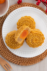 Delicious Cantonese moon cake for Mid-Autumn Festival food mooncake on wooden table background.