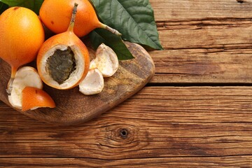 Delicious ripe granadillas on wooden table, top view. Space for text