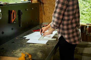Female interior designer working on drawings, woman architect draws
