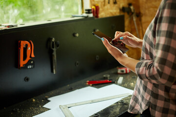 Female business owner using digital tablet in workshop