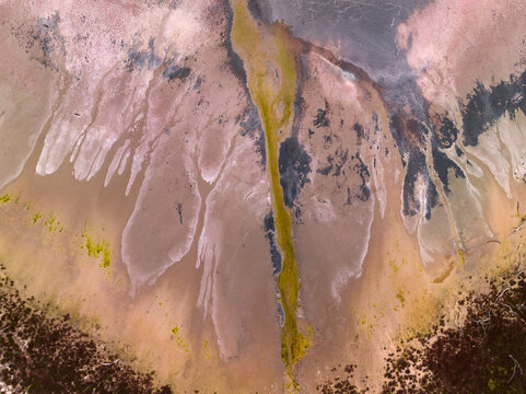 Aerial view of colourful patterns and textures in a dry salt lake