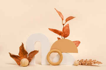 Autumn composition from wood toys and colorful falling leaves on light background. autumn festival...