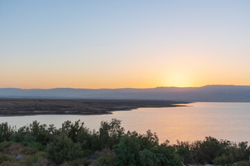 Fototapeta na wymiar Orange sunrise reflecting off of the Dead Sea. High quality photo