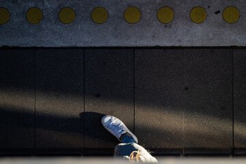Copenhagen, Denmark Train tracks and a patterned platform for safety. and a person's foot.