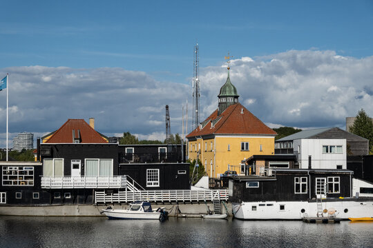 Copenhagen, Denmark Small houses on a canal and a canal boat.