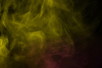 Obraz na płótnie Canvas Yellow and pink steam on a black background.