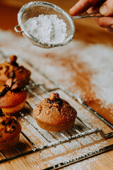 Sugar powder pouring on baked pastry