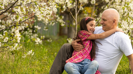 Fototapeta premium Grandfather And granddaughter on flower farm