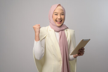 Beautiful musllim woman with hijab using tablet over white background, technology concept. .