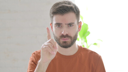 Rejecting Young Man showing No Sign by Finger Sign
